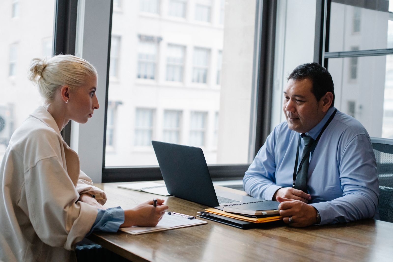 Two professionals in a focused recruiting interview